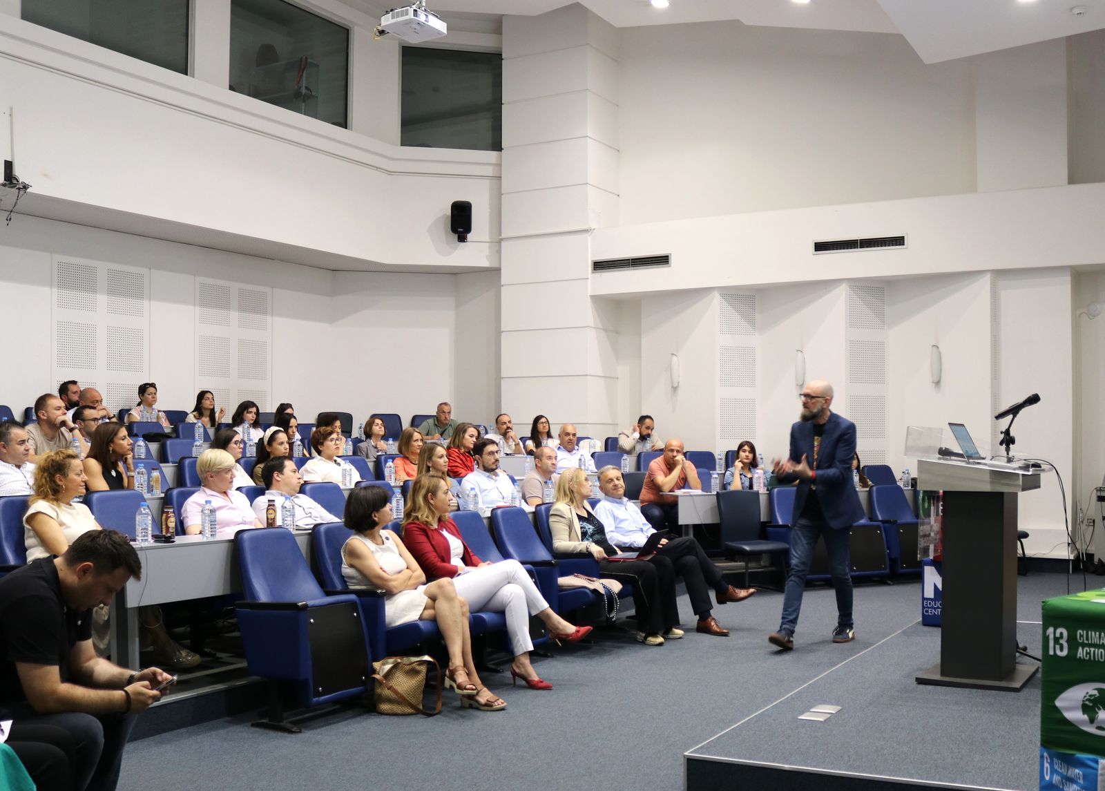 A speaker addressing an audience in the M6 amphitheatre